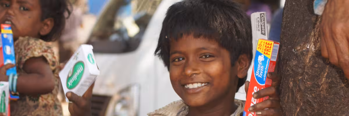 Street Child In Mapusa Holiding His Donations Aloft.