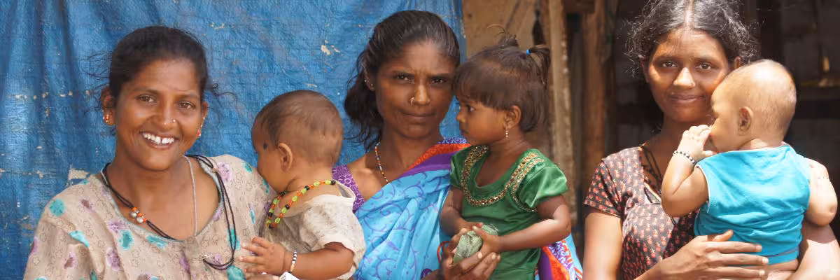 Mothers In The Slum With Their Children.